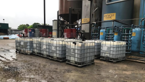 Intermediate Bulk Containers (IBCs) and barrels of scheduled waste at a recovery and recycle facility.
