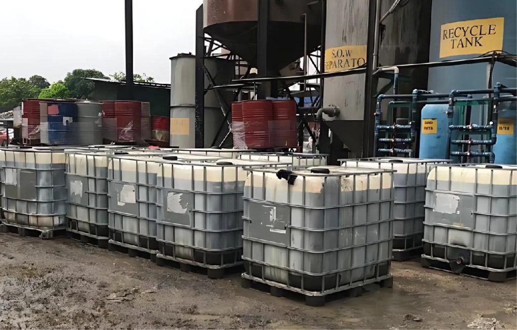 Intermediate Bulk Containers (IBCs) and barrels of scheduled waste at a recovery and recycle facility.